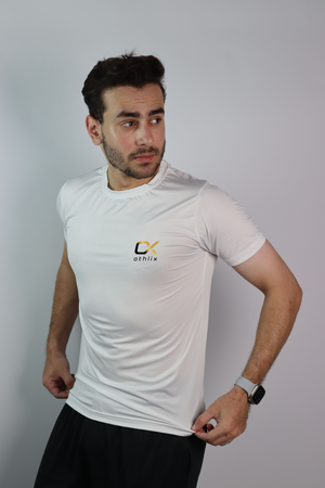 A man wearing an Athlix white performance tee against a light studio background.